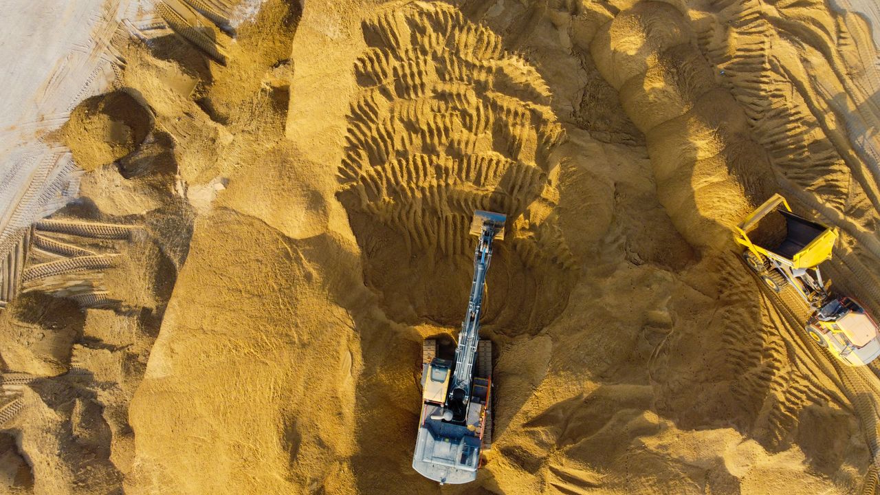 Services Drone shot of excavators at work in sandy construction site, Ashdod, Israel.